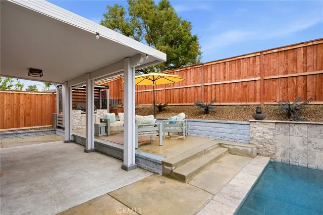 a view of a patio with a table and chairs