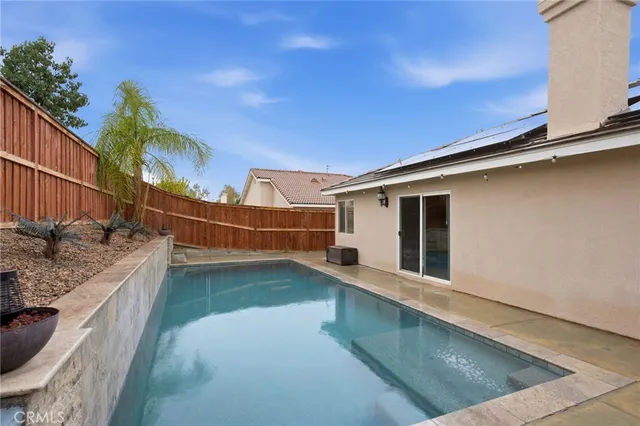 a view of a backyard with swimming pool