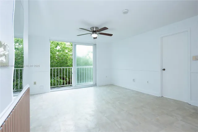 a view of a room with a ceiling fan