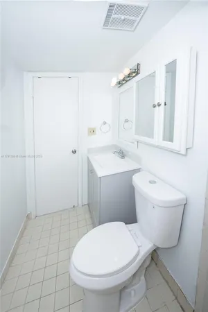 an empty room with a window and a ceiling fan