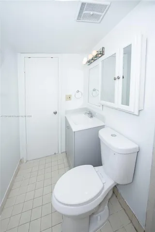 an empty room with a window and a ceiling fan