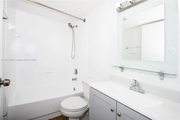 a white toilet sitting next to a bathroom sink