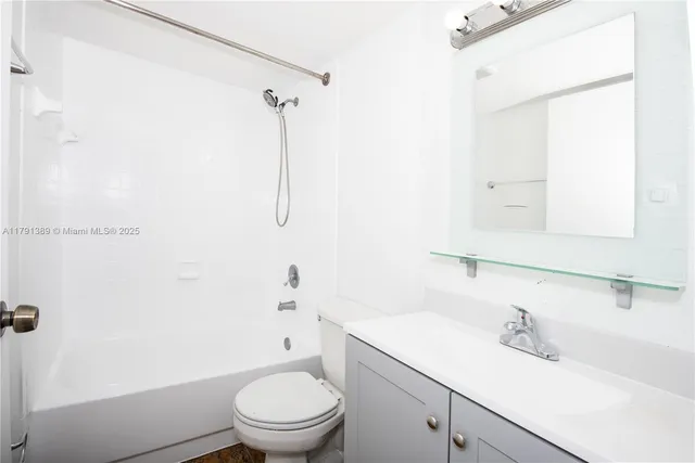 a white toilet sitting next to a bathroom sink