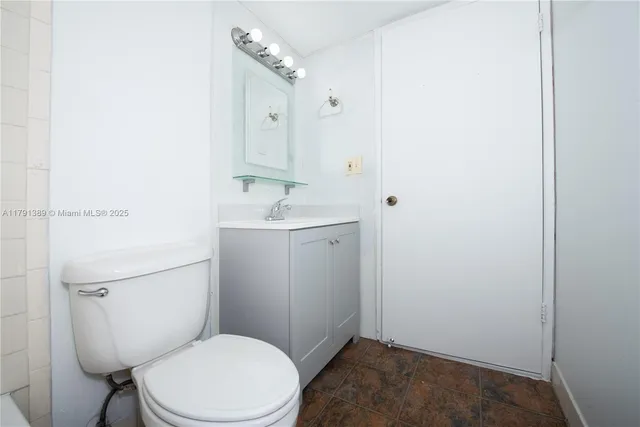 a white toilet sitting next to a bathroom sink