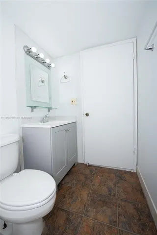 a kitchen with stainless steel appliances granite countertop a refrigerator a stove a sink and white cabinets