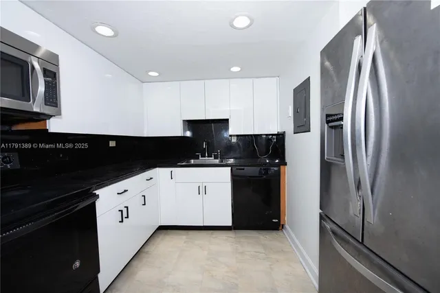 a kitchen with stainless steel appliances a refrigerator and a stove top oven