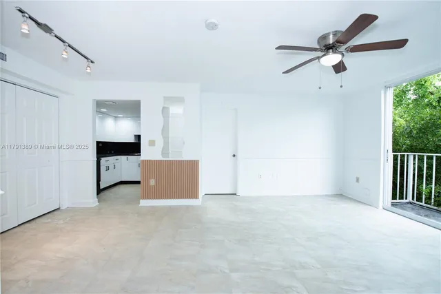 a view of an empty room with a ceiling fan