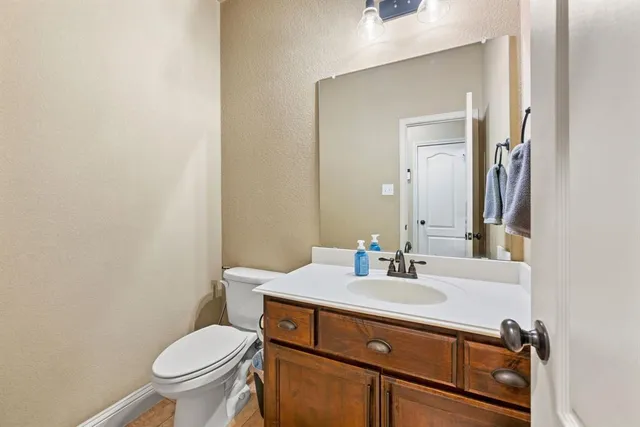 a bathroom with a sink toilet and mirror