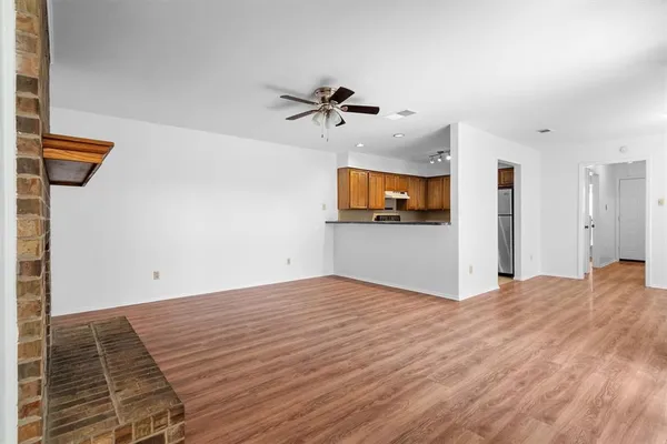 a view of a livingroom with a fireplace and a ceiling fan