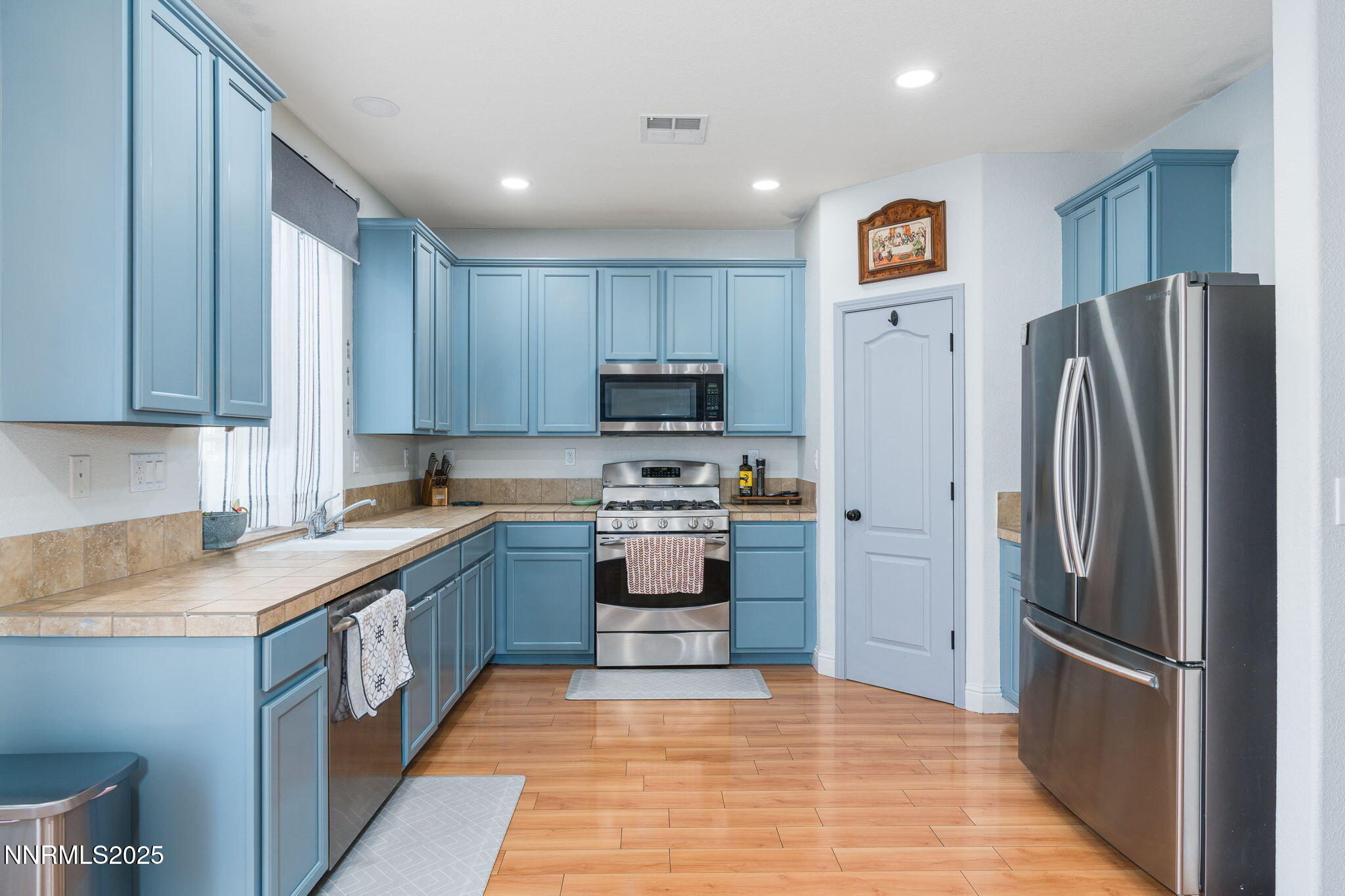 7220 Windswept Loop Sparks, NV 89436 - Photo 12 of 35 a kitchen with stainless steel appliances granite countertop a refrigerator stove and oven