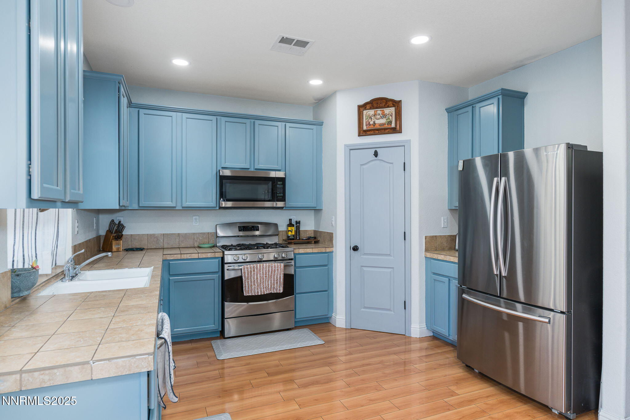 7220 Windswept Loop Sparks, NV 89436 - Photo 13 of 35 a kitchen with stainless steel appliances granite countertop a refrigerator and a stove top oven