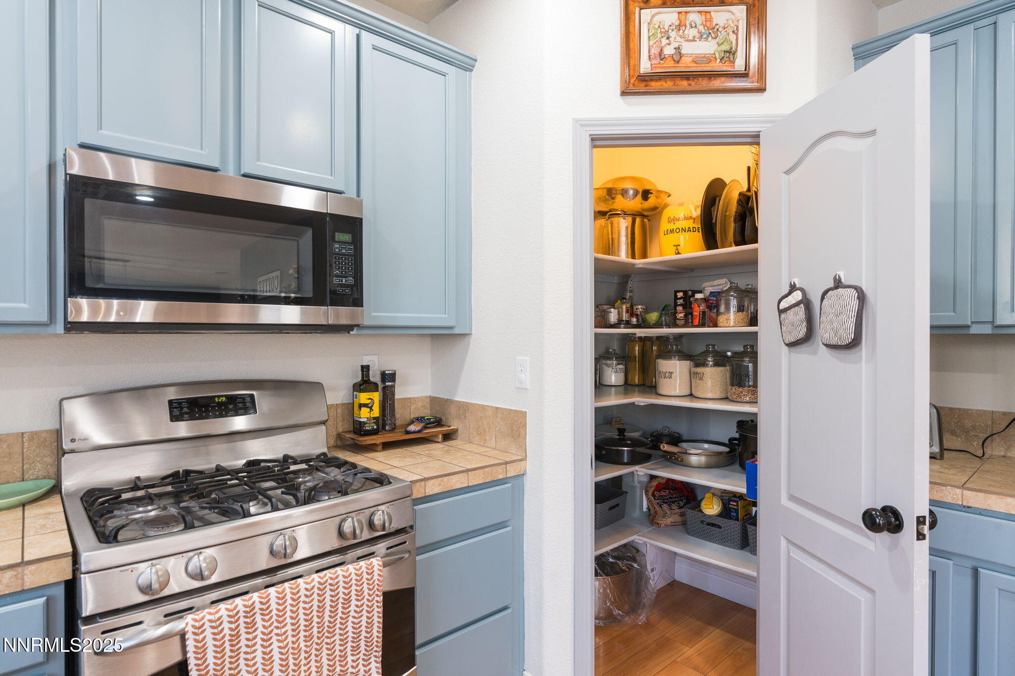 7220 Windswept Loop Sparks, NV 89436 - Photo 14 of 35 a kitchen with stainless steel appliances granite countertop a stove and a microwave