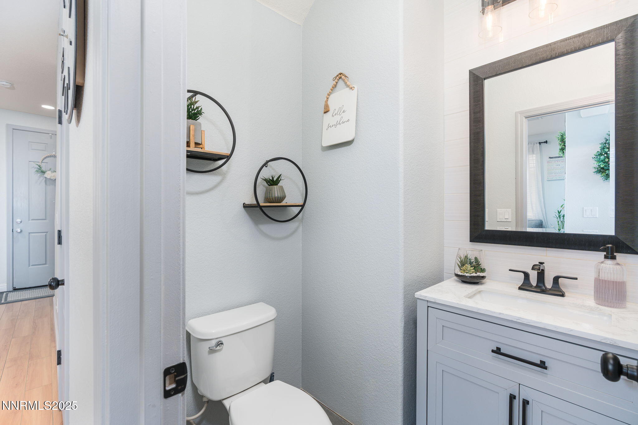 7220 Windswept Loop Sparks, NV 89436 - Photo 17 of 35 a bathroom with a toilet sink vanity and mirror