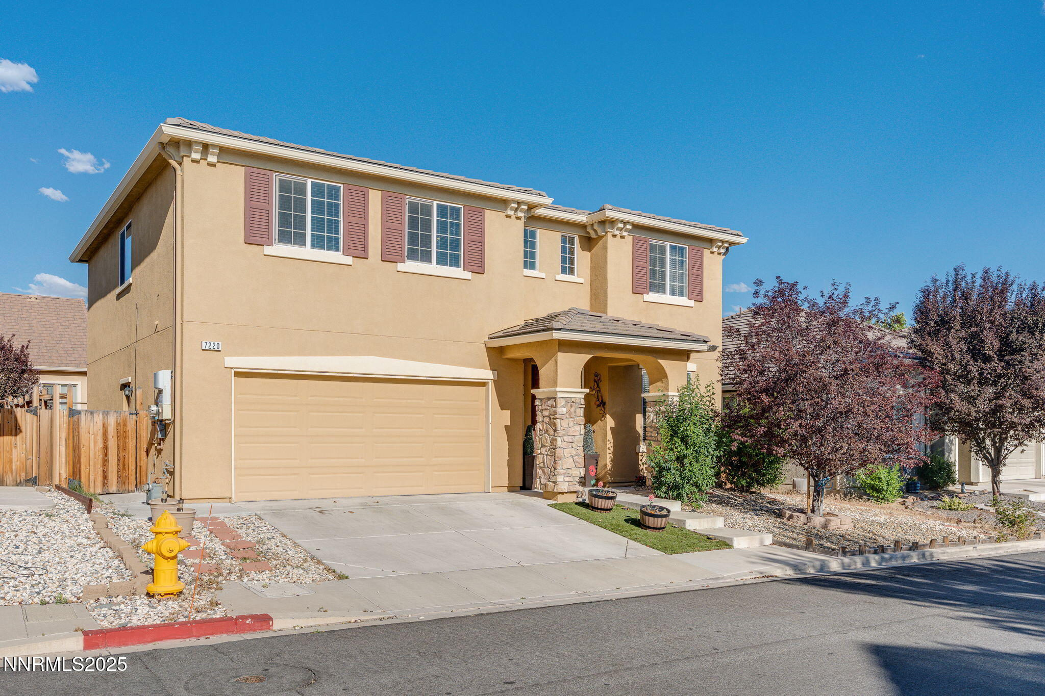7220 Windswept Loop Sparks, NV 89436 - Photo 2 of 35 a front view of a house with a yard and garage