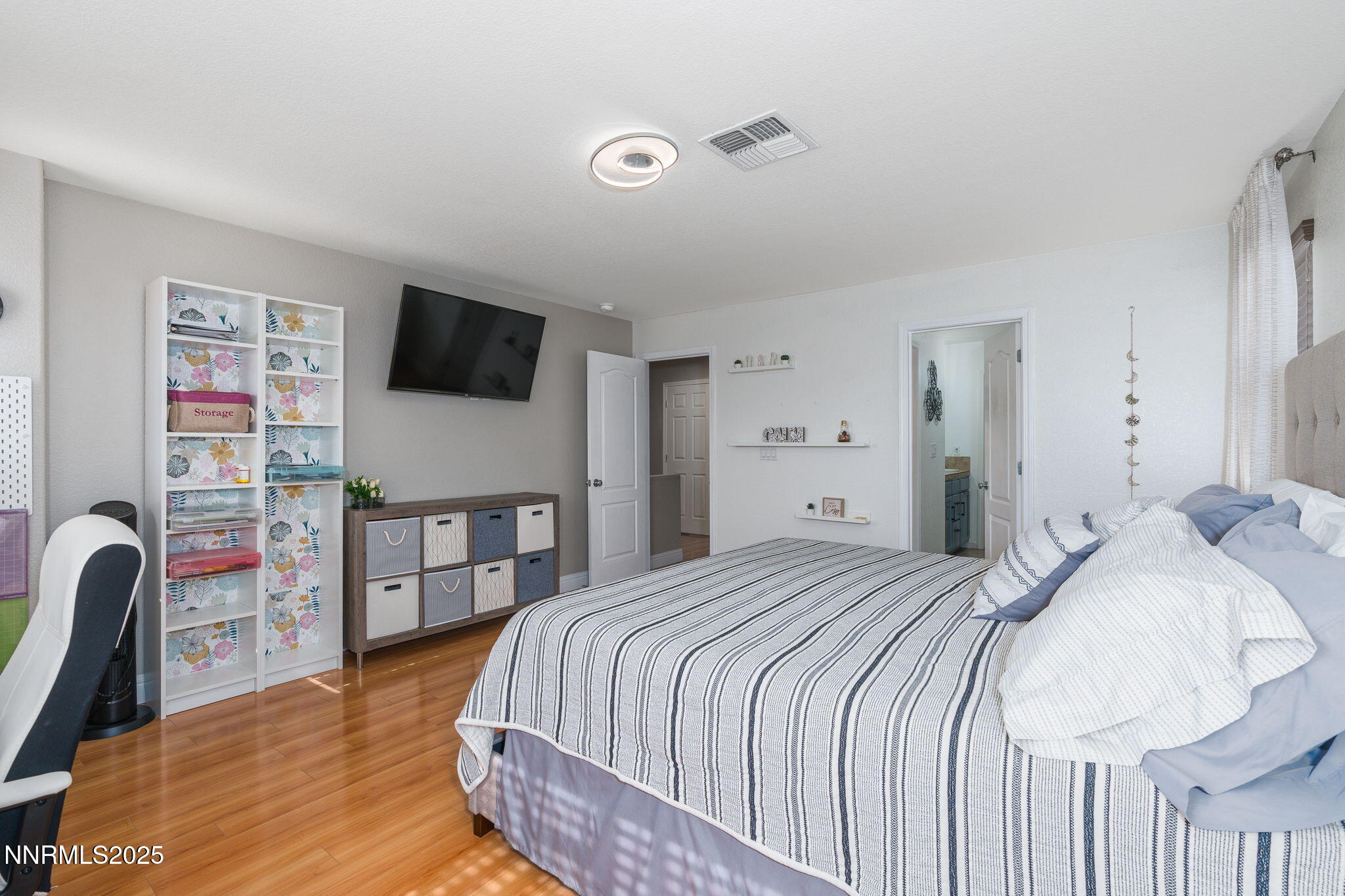 7220 Windswept Loop Sparks, NV 89436 - Photo 21 of 35 a bedroom with a bed and a flat screen tv