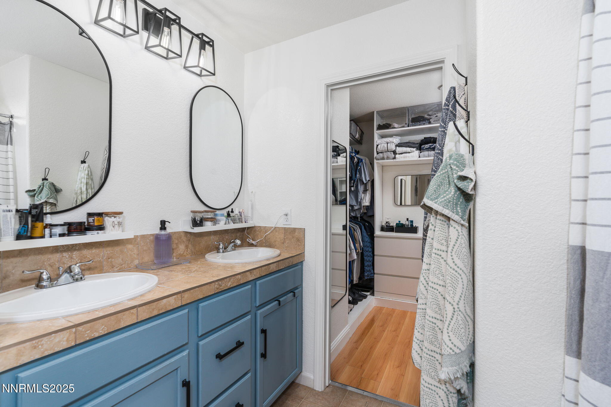 7220 Windswept Loop Sparks, NV 89436 - Photo 24 of 35 a bathroom with a double vanity sink and a mirror