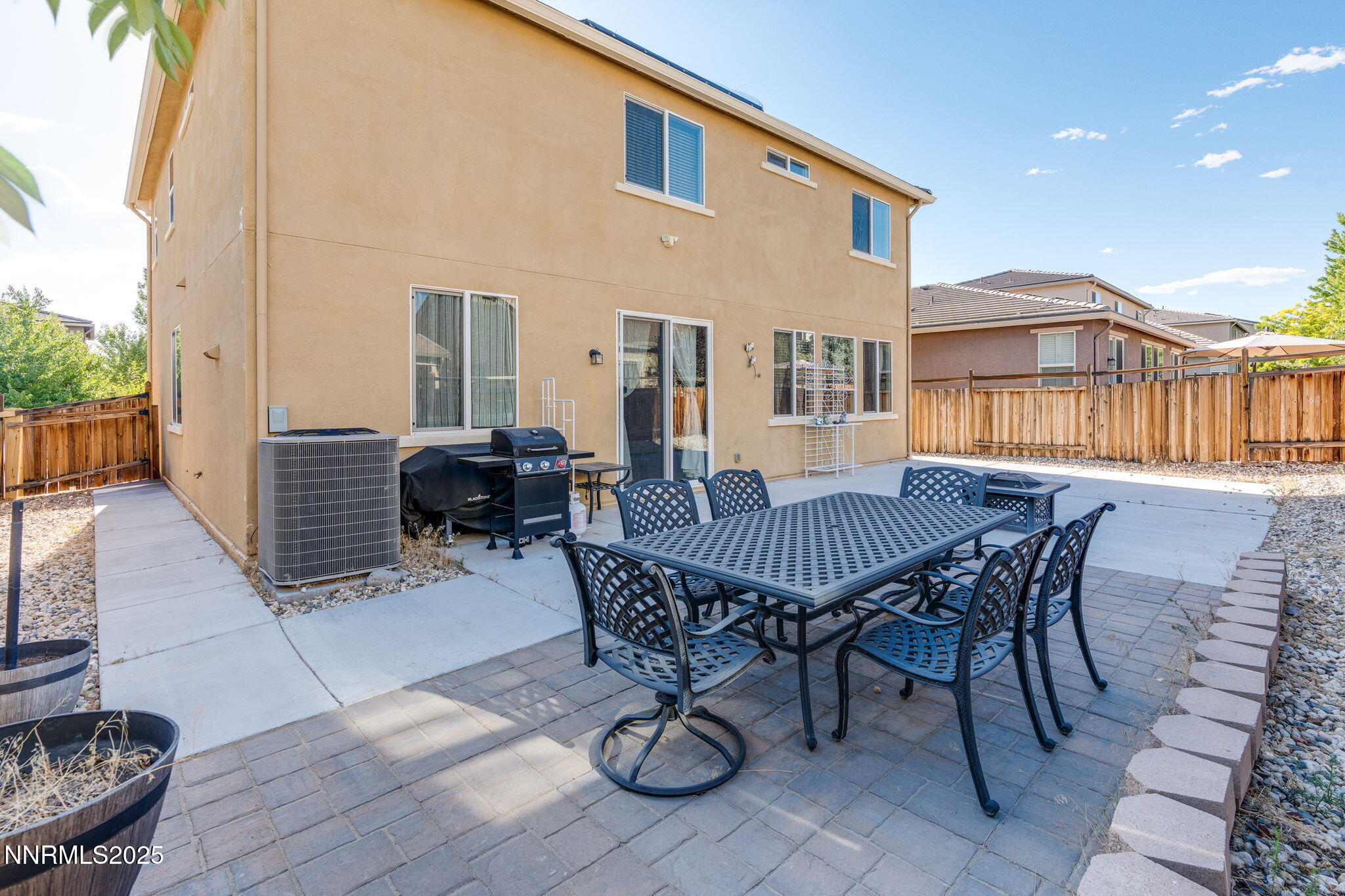 7220 Windswept Loop Sparks, NV 89436 - Photo 33 of 35 a view of a patio with table and chairs with wooden floor and fence