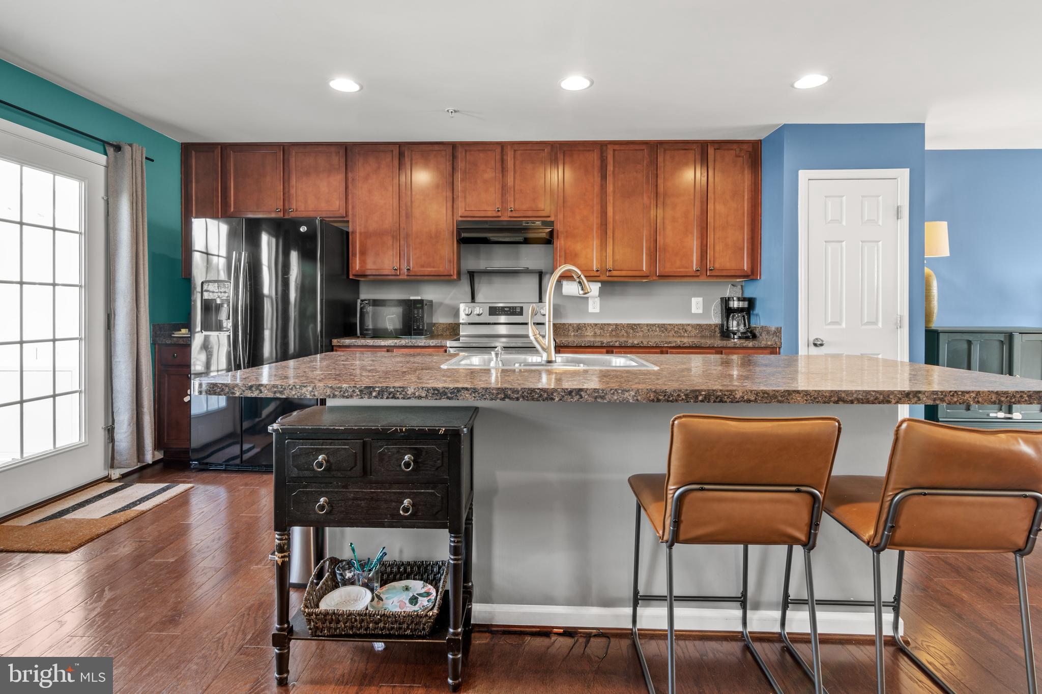 1342 Millar Road Aberdeen, MD 21001 - Photo 5 of 34 a kitchen with stainless steel appliances granite countertop a stove top oven a refrigerator a sink and a chairs