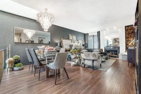 a dining room with furniture and wooden floor