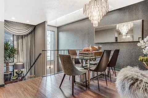 a kitchen with stainless steel appliances a stove a refrigerator a sink a stove and cabinets