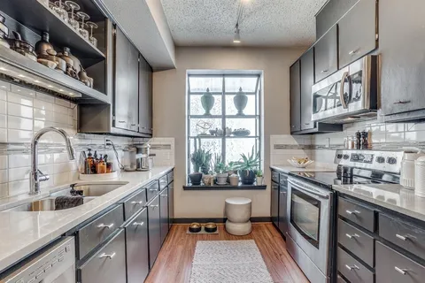 a bathroom with a granite countertop toilet a sink and a mirror