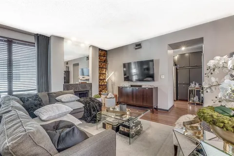 a living room with furniture and a chandelier