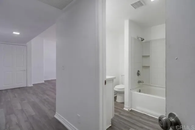 a bathroom with a bathtub and a toilet