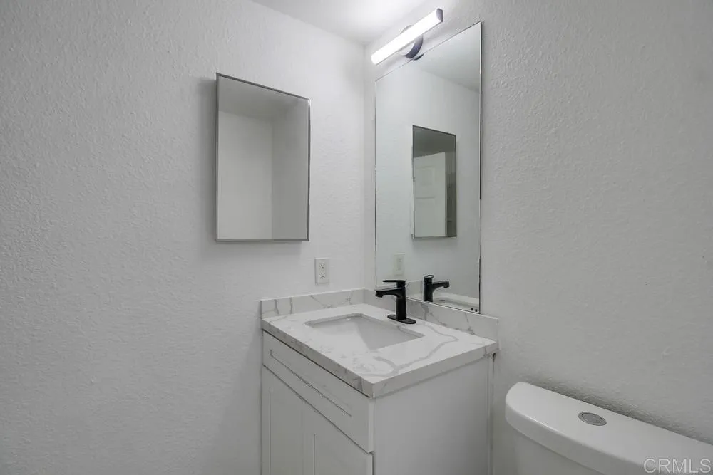 734 Grand Avenue Spring Valley, CA 91977 - Photo 21 of 33 a bathroom with a toilet sink and mirror