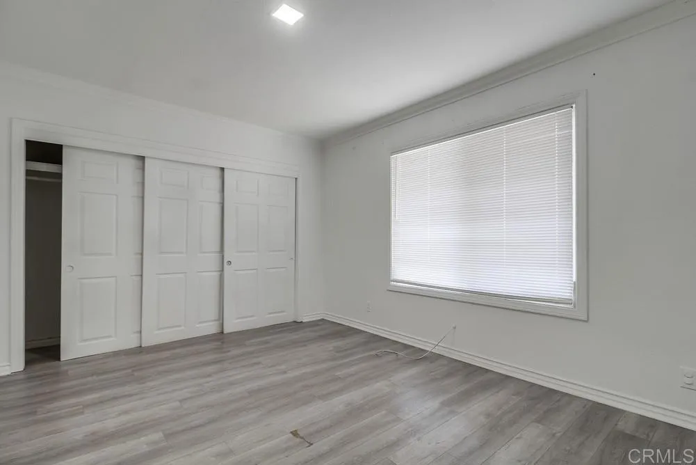 734 Grand Avenue Spring Valley, CA 91977 - Photo 24 of 33 an empty room with wooden floor and windows