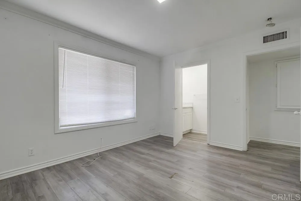 734 Grand Avenue Spring Valley, CA 91977 - Photo 25 of 33 an empty room with wooden floor and windows