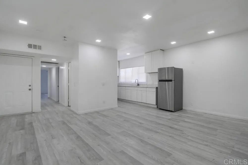 734 Grand Avenue Spring Valley, CA 91977 - Photo 5 of 33 a view of an empty room with wooden floor and a kitchen