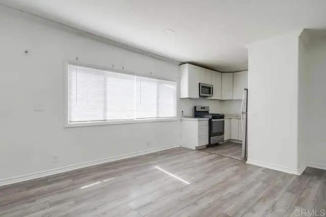 a kitchen with granite countertop a stove a sink and a refrigerator