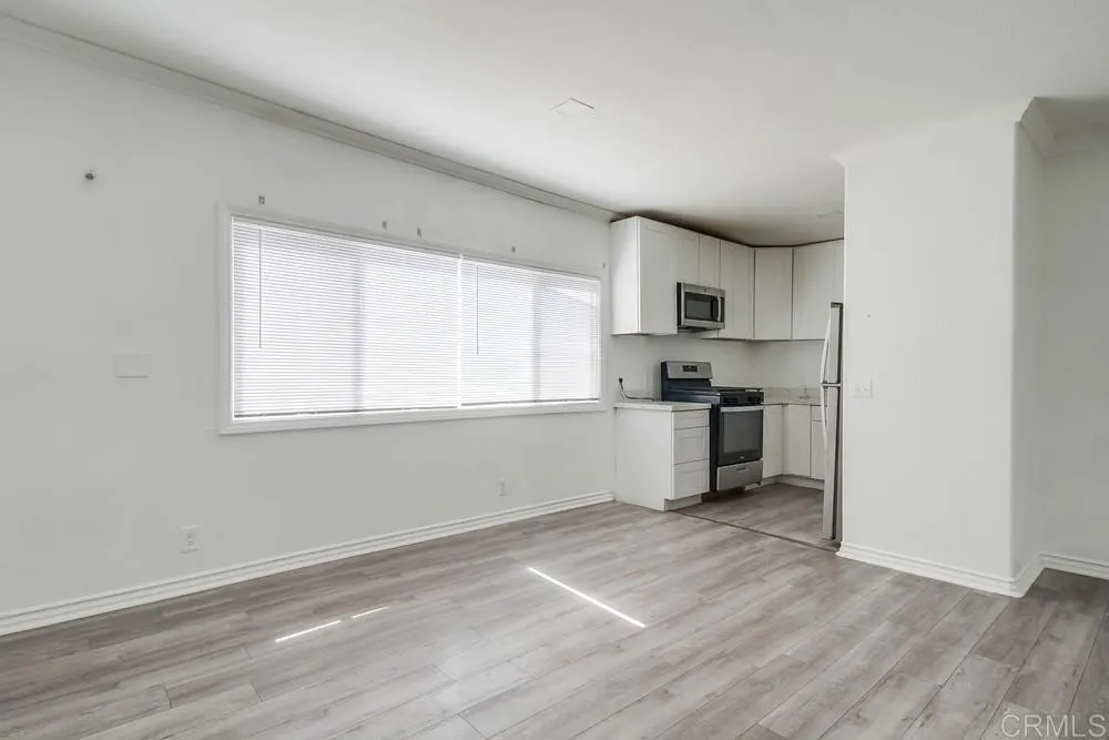 734 Grand Avenue Spring Valley, CA 91977 - Photo 7 of 33 a kitchen with granite countertop a stove a sink and a refrigerator