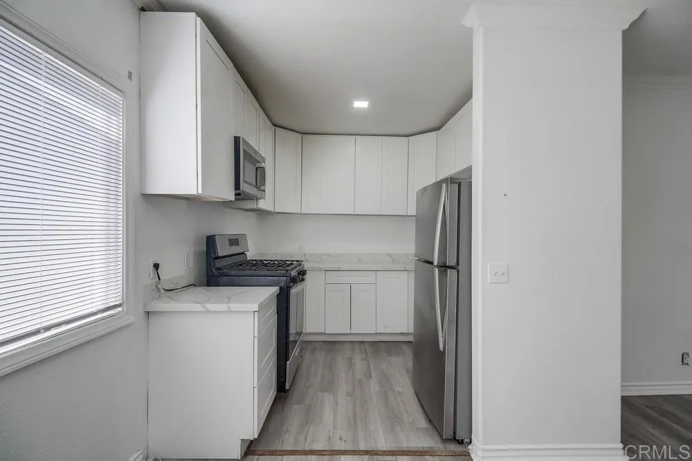 734 Grand Avenue Spring Valley, CA 91977 - Photo 10 of 33 a kitchen with stainless steel appliances granite countertop a refrigerator and a stove top oven