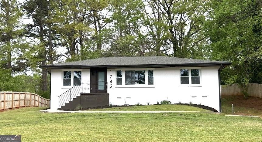 a house that has a big yard in front of it