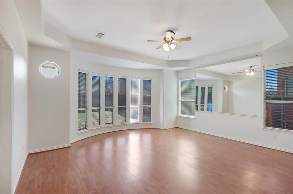 9618 Peach Tree Lane Rowlett, TX 75089 - Photo 12 of 40 a view of an empty room with wooden floor and a window