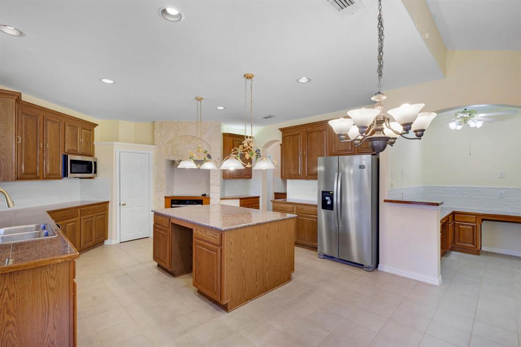 9618 Peach Tree Lane Rowlett, TX 75089 - Photo 17 of 40 a kitchen that has a lot of cabinets and refrigerator