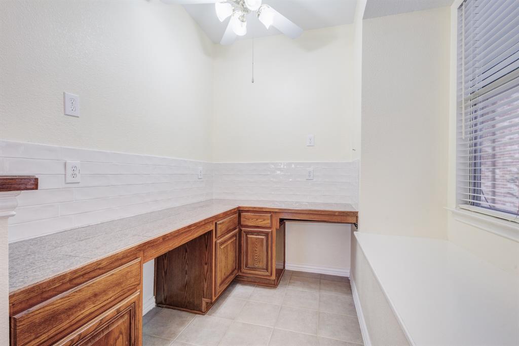 9618 Peach Tree Lane Rowlett, TX 75089 - Photo 19 of 40 a kitchen with a sink and cabinets