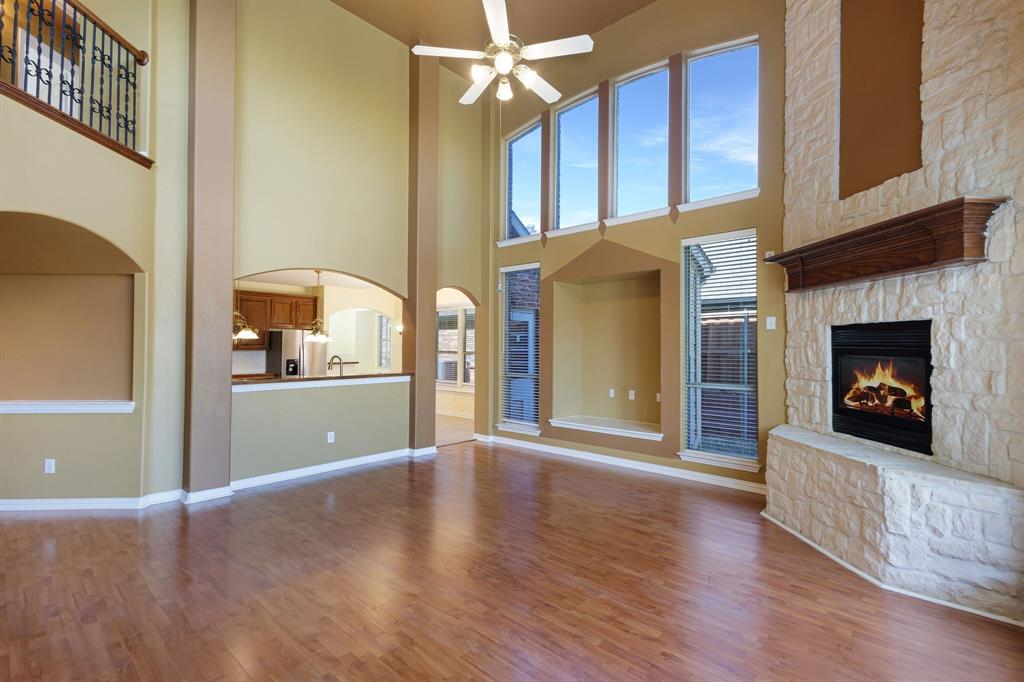 9618 Peach Tree Lane Rowlett, TX 75089 - Photo 20 of 40 a view of a livingroom with wooden floor and a fireplace