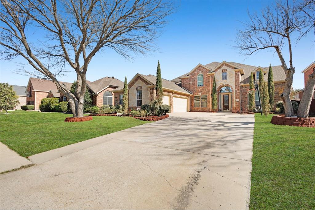 9618 Peach Tree Lane Rowlett, TX 75089 - Photo 2 of 40 a view of a white house with a yard