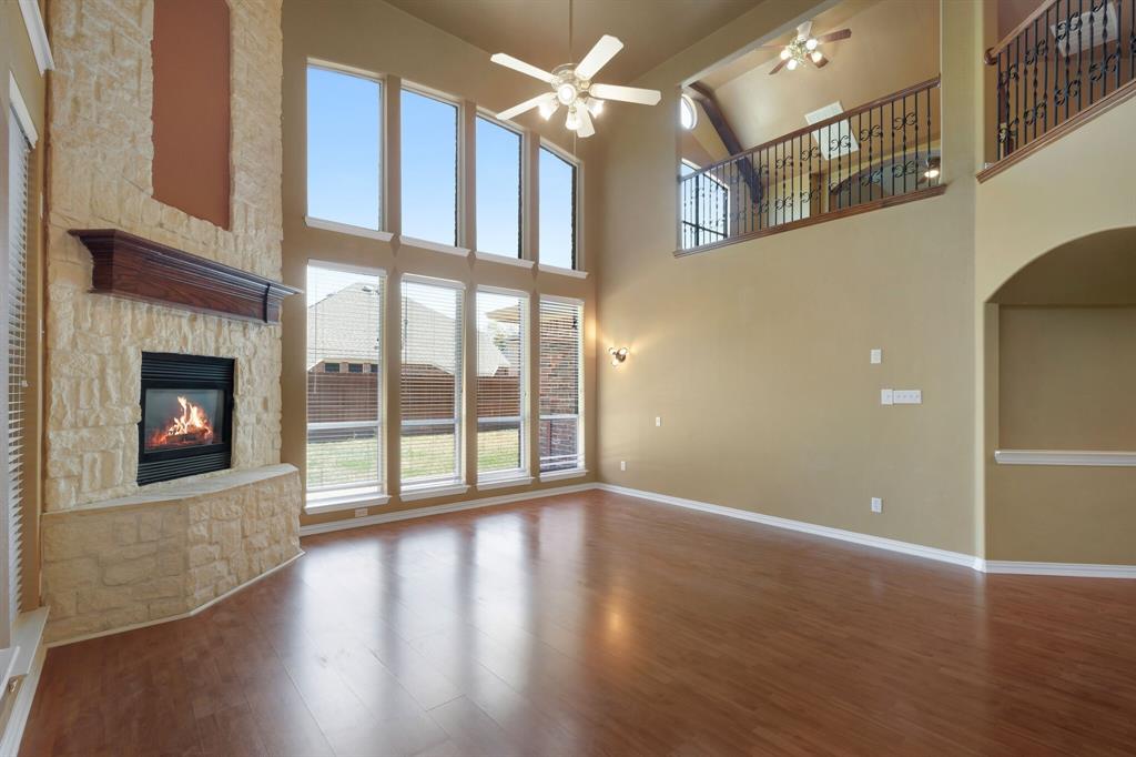 9618 Peach Tree Lane Rowlett, TX 75089 - Photo 21 of 40 a view of an empty room with wooden floor and a fireplace