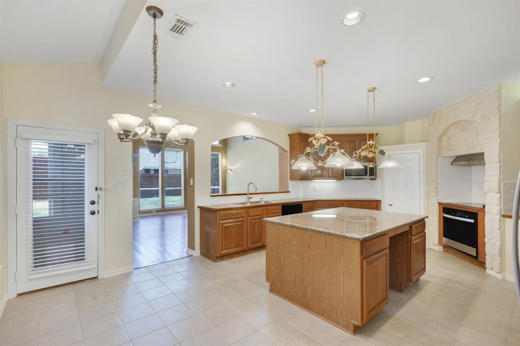 9618 Peach Tree Lane Rowlett, TX 75089 - Photo 22 of 40 a kitchen with granite countertop a sink a counter top space appliances and cabinets