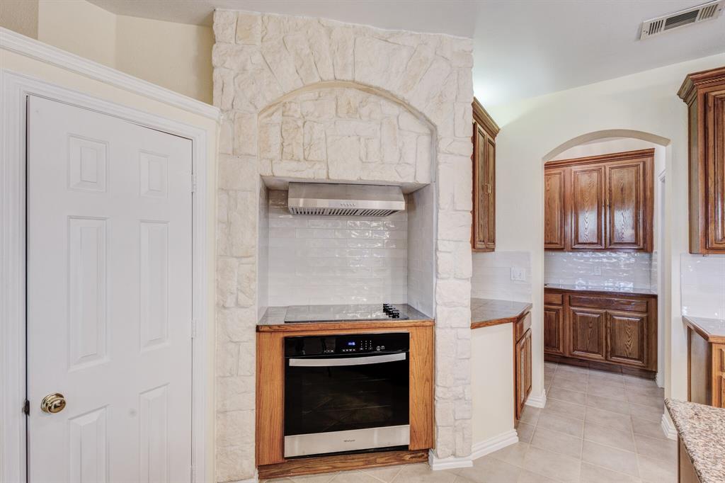 9618 Peach Tree Lane Rowlett, TX 75089 - Photo 24 of 40 a stove top oven sitting inside of a kitchen