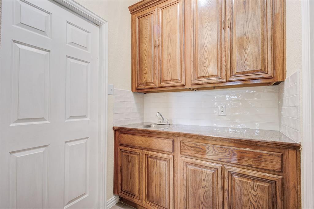 9618 Peach Tree Lane Rowlett, TX 75089 - Photo 26 of 40 a view of a kitchen with white cabinets