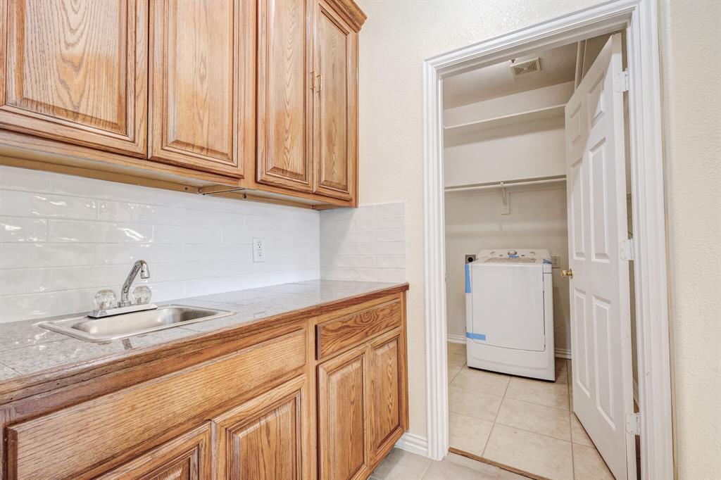 9618 Peach Tree Lane Rowlett, TX 75089 - Photo 27 of 40 a kitchen with a sink and cabinets