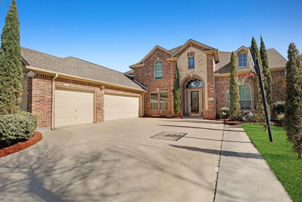 9618 Peach Tree Lane Rowlett, TX 75089 - Photo 3 of 40 a view of a white house with a large windows and a yard with plants