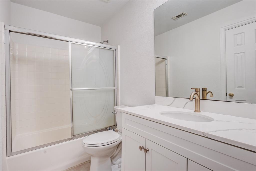 9618 Peach Tree Lane Rowlett, TX 75089 - Photo 35 of 40 a bathroom with a sink toilet and shower