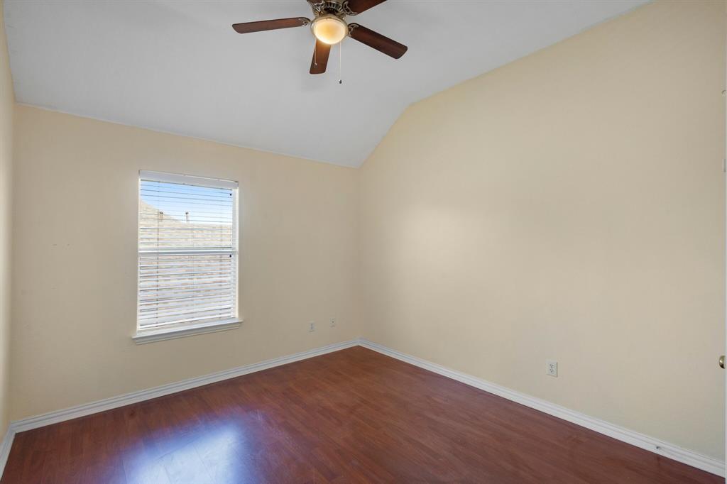 9618 Peach Tree Lane Rowlett, TX 75089 - Photo 36 of 40 an empty room with a window and a ceiling fan