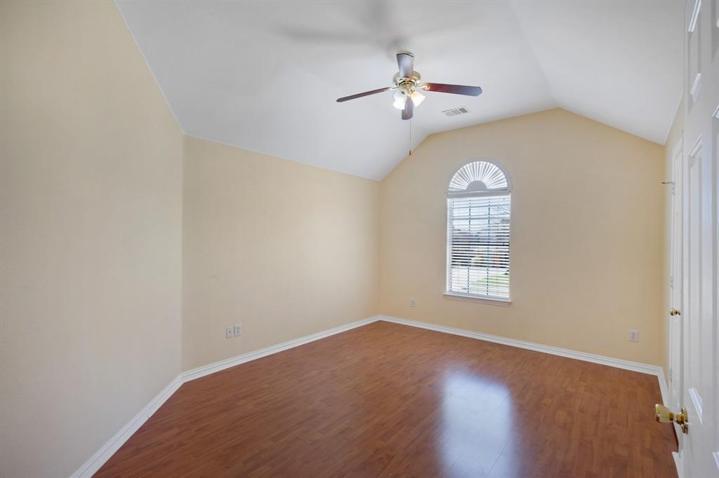 9618 Peach Tree Lane Rowlett, TX 75089 - Photo 37 of 40 an empty room with chandelier fan and windows