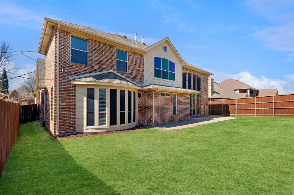 9618 Peach Tree Lane Rowlett, TX 75089 - Photo 40 of 40 a front view of a house with a yard
